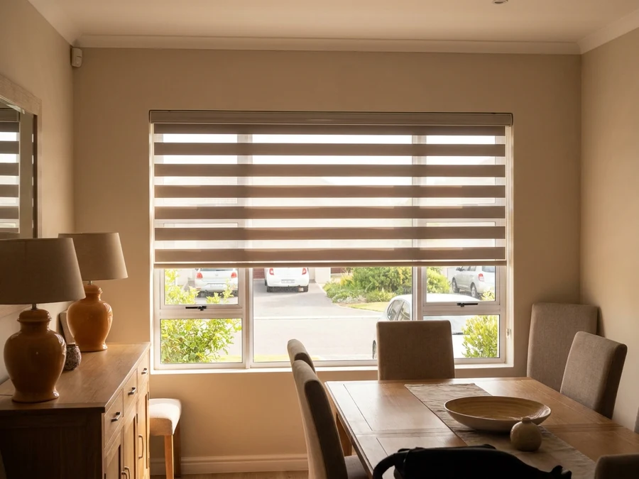 Day and night zebra-banded blind on a street-facing dining room window in Brackenfell