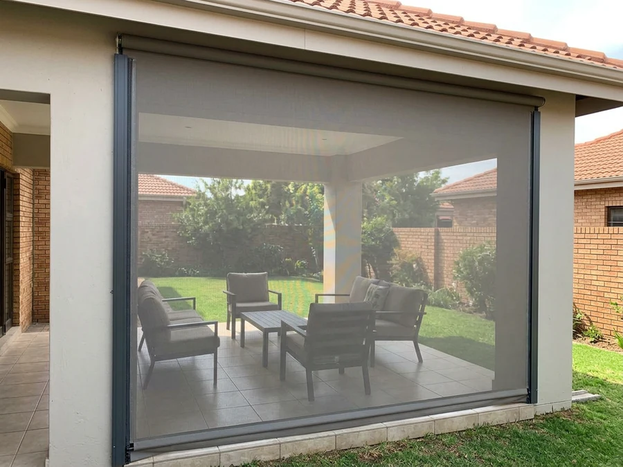 Outdoor zip screen lowered over a covered patio at a Brackenfell home